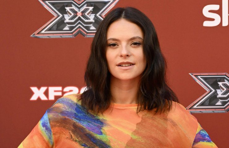 FrancescaMichielin con maglia colorata davanti a banner di X Factor